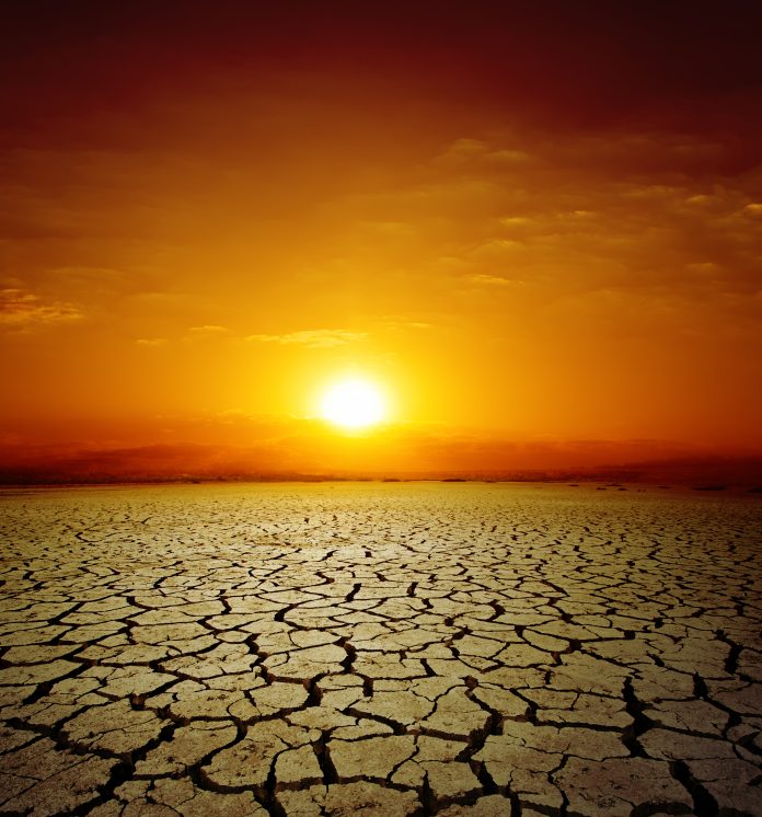 red sunset over drought earth. change of climate