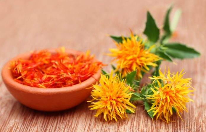 Safflower is a food additive on wooden surface