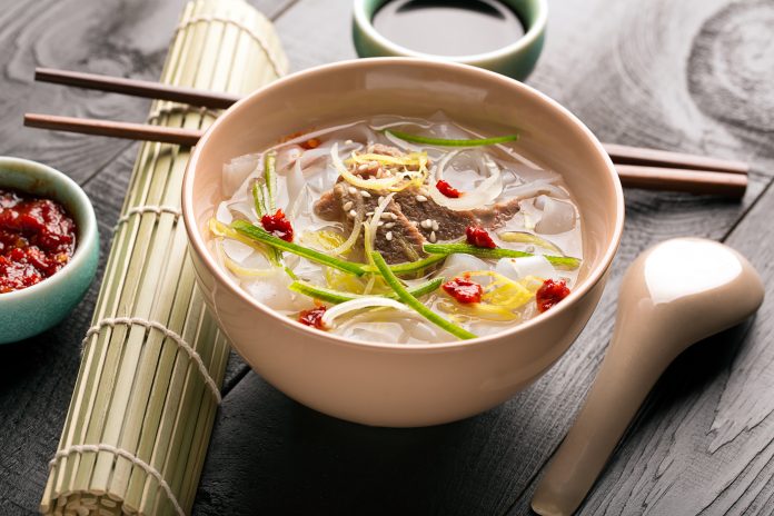 Traditional chinese noodle soup with vegetables and onion