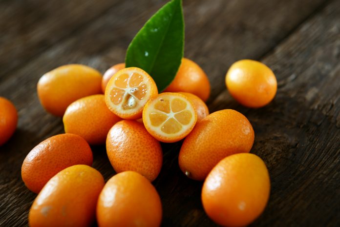 Kumquat fruits on old wooden table
