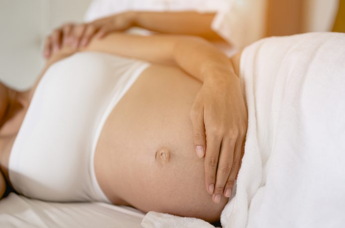 Pregnant women are enjoying a relaxing massage in bed at home. To treat and care for the mental health of the fetus Prenatal and Pregnancy Care Concept of Women