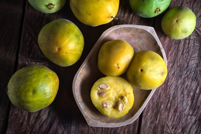 rare araza fruits in a wooden bowl on rustic background