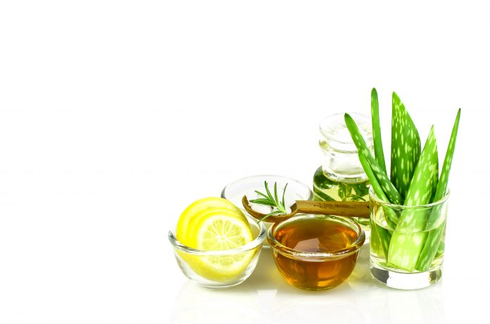 Aloe Vera, Lemon, greek yogurt, honey, rosemary, sea salt and essential oil homeopathy remedy recipe on white background.