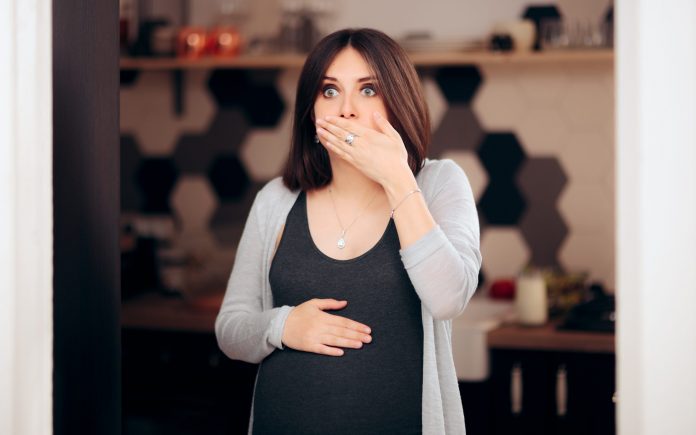 Girl experiencing morning sickness in difficult pregnancy