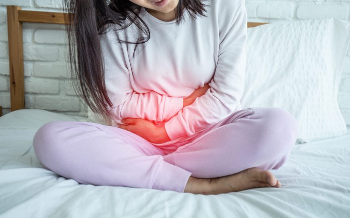woman have bladder pain sitting on bed in bedroom after wake up feeling so sick and painful,Healthcare concept