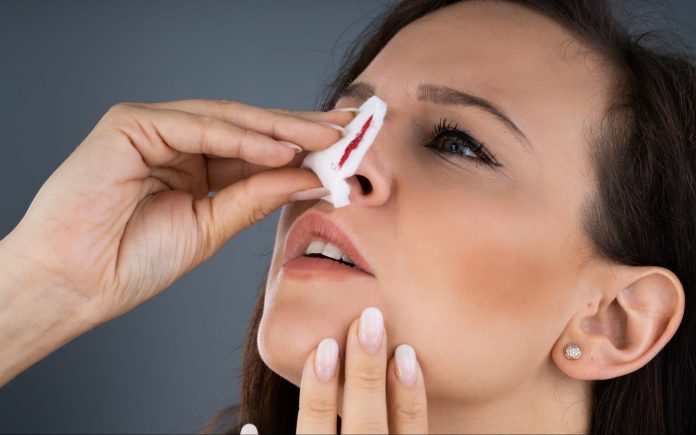 Woman Trying To Stop Blood Bleeding From Nose