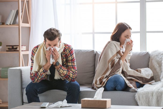 Young woman and man family couple indoors sick