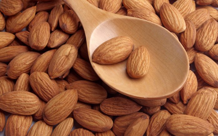 almonds on wooden spoon