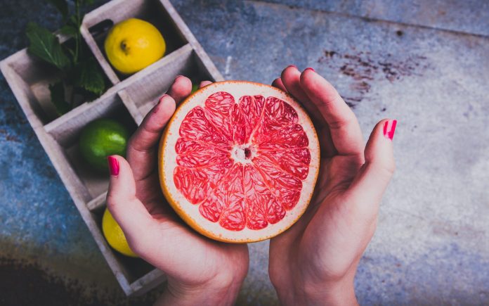 Woman holding a grapefruit