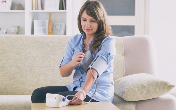 Women checking blood pressure at home